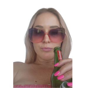 30 plus woman with pink nails and pink sunglasses drinking a Steinlager beer for New Years Eve