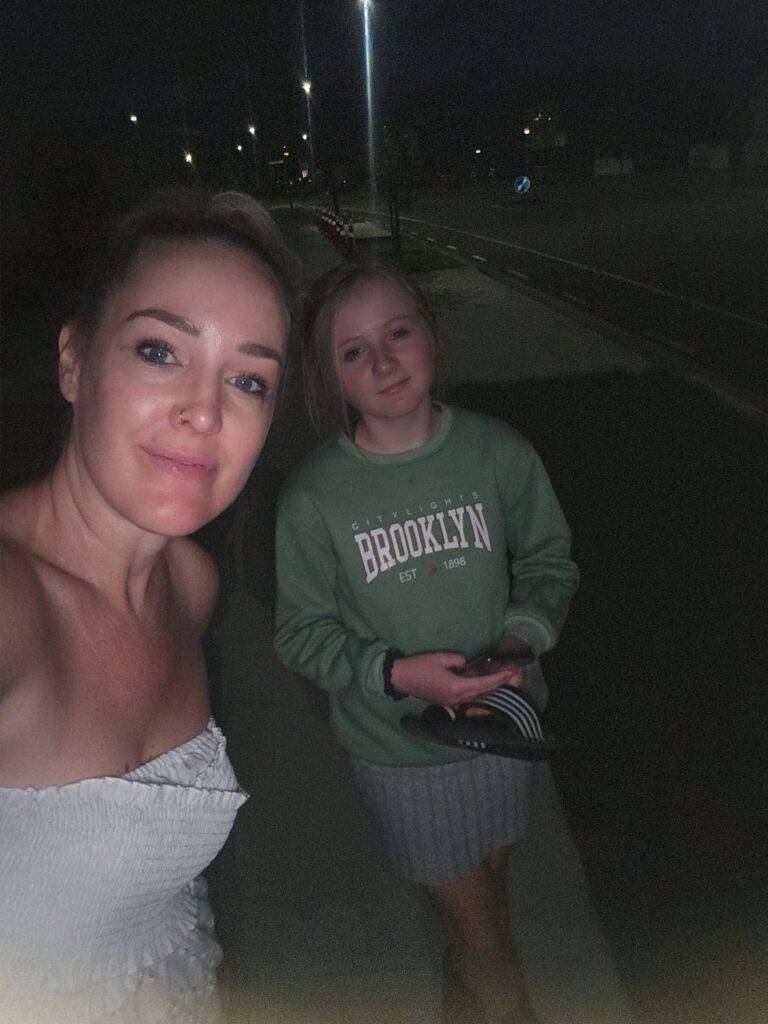 Mum and daughter taking a photo in the dark